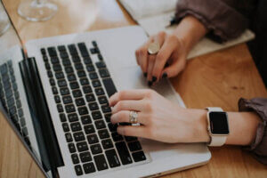 Woman's hands typing on laptop keyboard