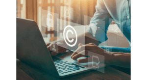 woman at desk with computer with copyright symbol floating above keyboard